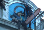 Click on image to see full-sized version riot cops in cherry picker pluck defender of space from Miles roof