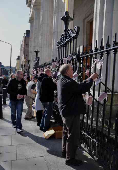Click on image to see full-sized version Protesters tying shoes to railings at the Pro Cathedral