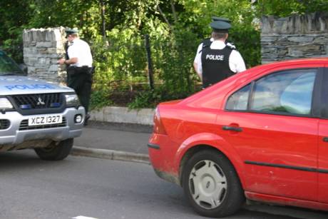 Click on image to see full-sized version Jim arrested in the back of the car